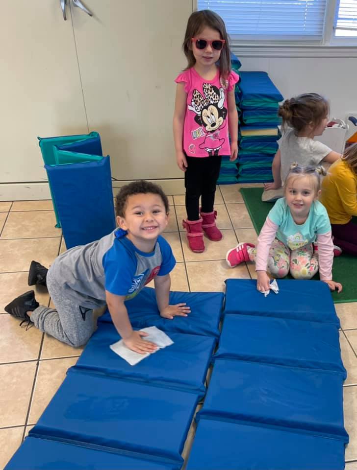 children helping keep mats clean