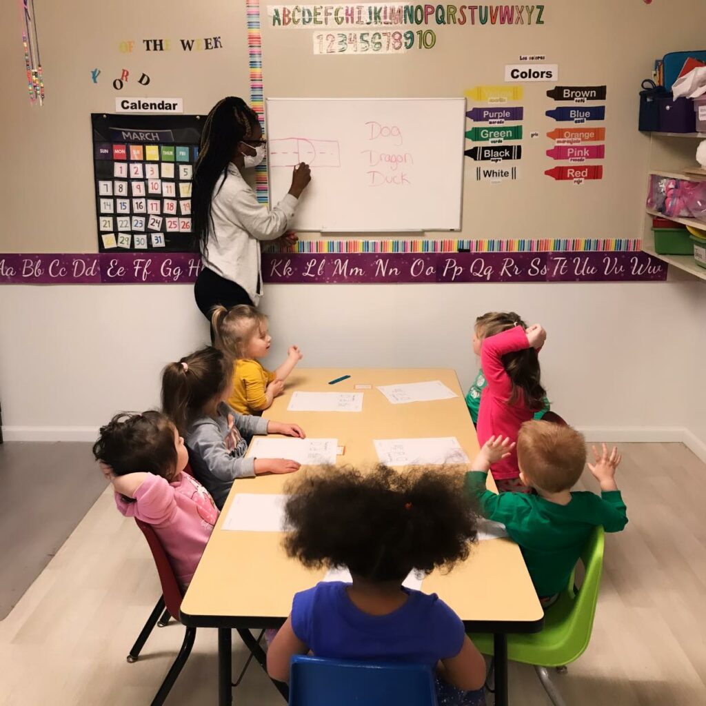 children learning letters from teacher